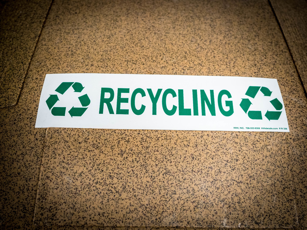 Image from recycling totes showing the word RECYCLING and recycle symbols